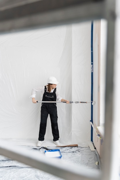 Decorator painting an interior wall in a Northampton home